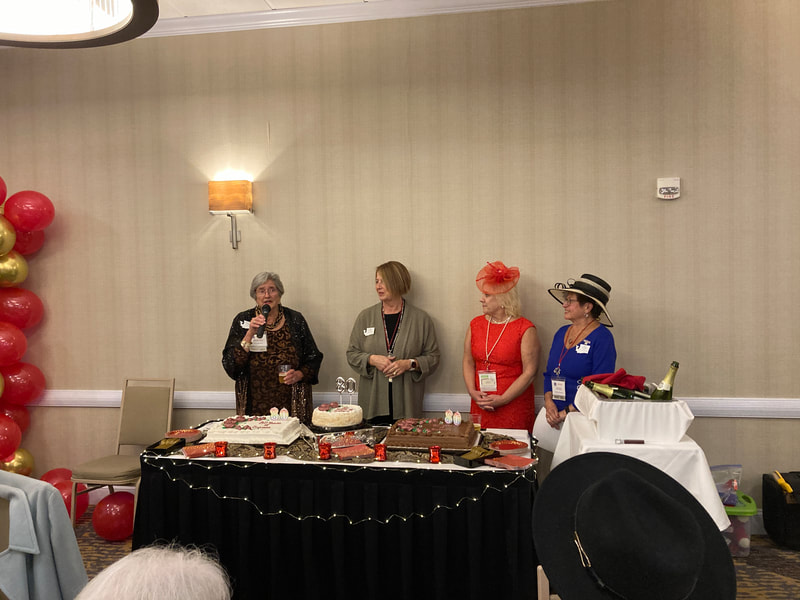 Past presidents of WFRW cut the cake for the celebration. 
