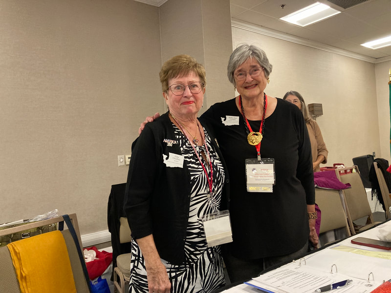 Past President Billie Jean presents President Ellie with a Resolution on her service. 